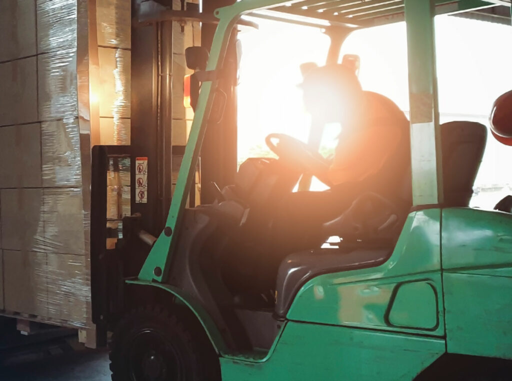Warehouse operator driving forklift